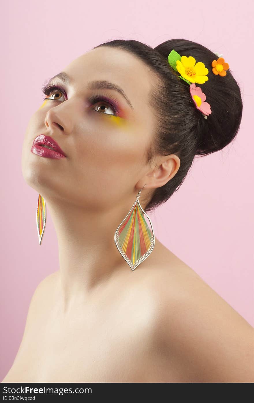 Close-up portrait of beautiful brunette with glamor make-up and color candy style