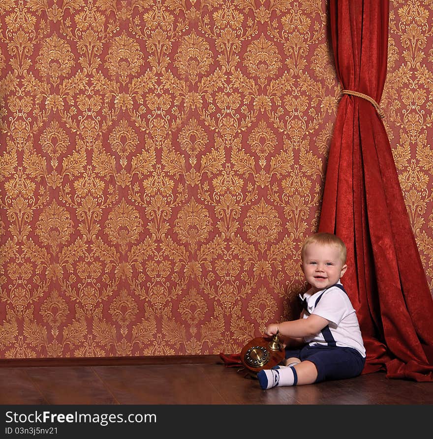 Child in a suit sitting in an vintage inter