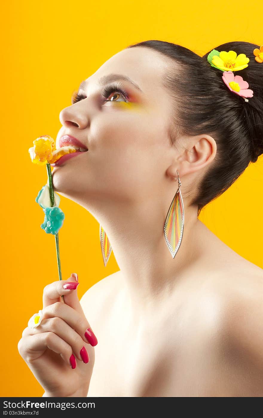 Close-up portrait of beautiful brunette with glamor make-up and color candy style