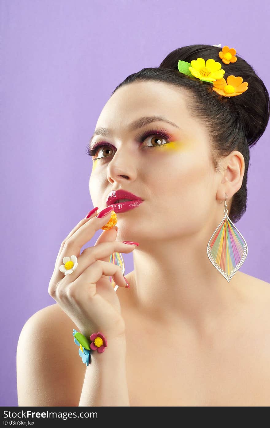 Close-up portrait of beautiful brunette with glamor make-up and color candy style