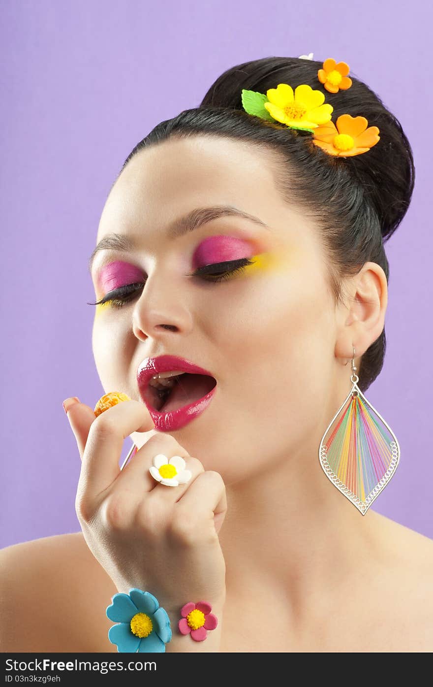 Close-up portrait of beautiful brunette with glamor make-up and color candy style