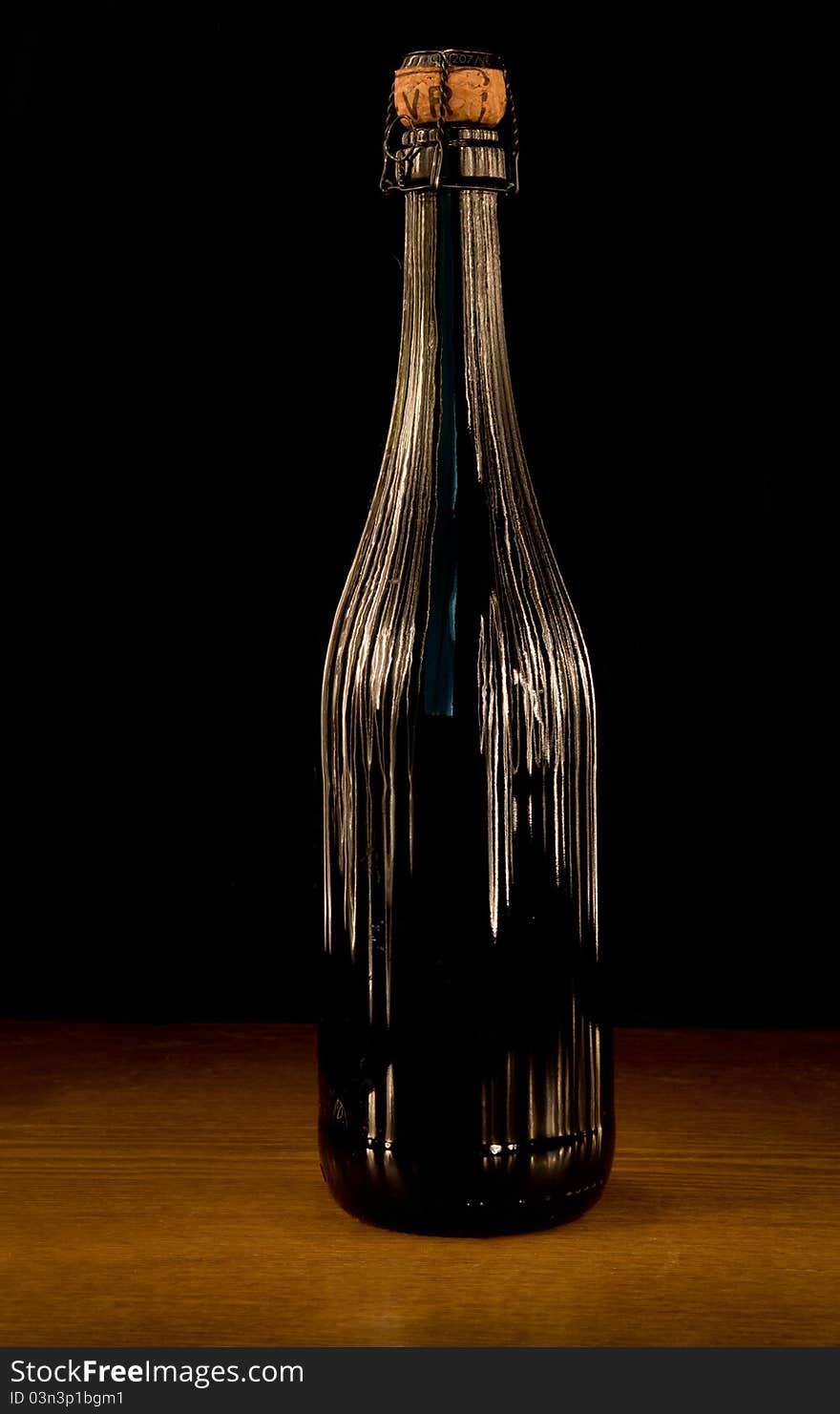 Wine Bottle with stripes of light on dark background