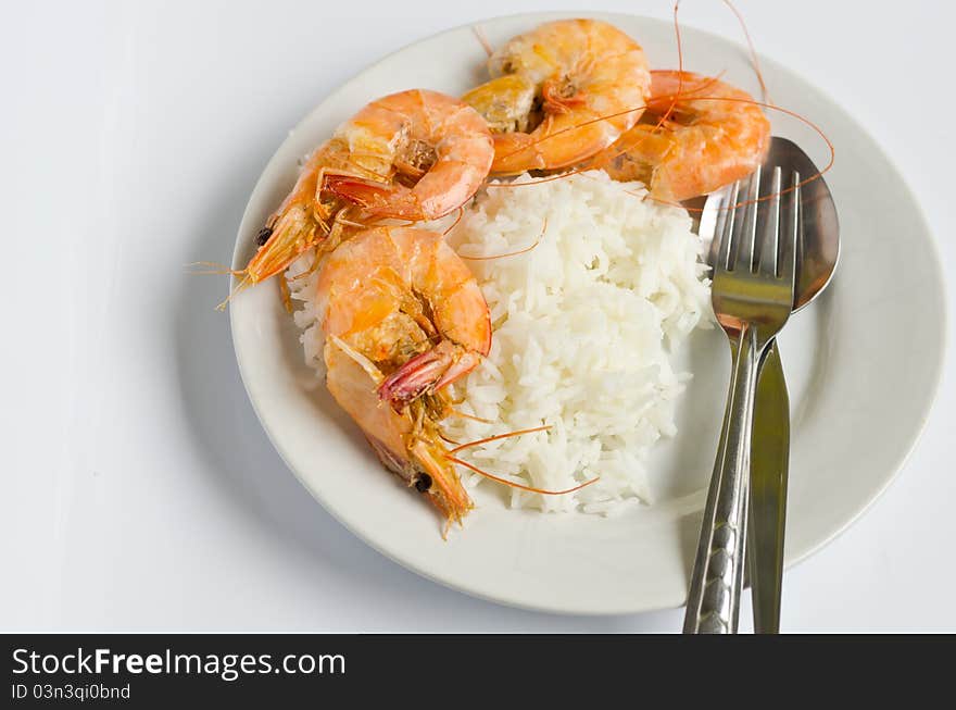 Baked shrimp with rice on white dish, ready to eat