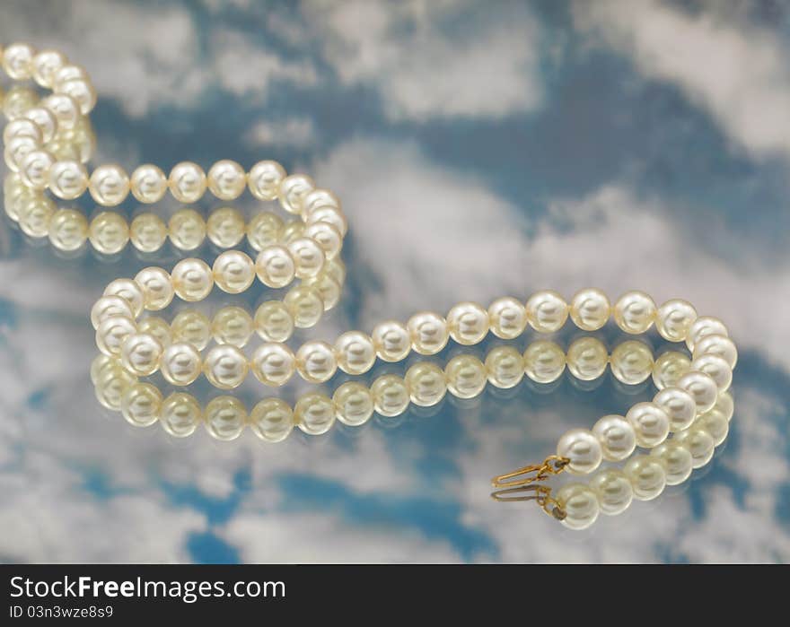 Elegant pearls with sky and reflection very shallow depth of field