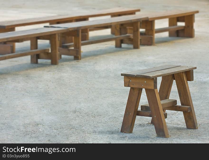 Concept - one chair for a leader in front of group benches. Concept - one chair for a leader in front of group benches