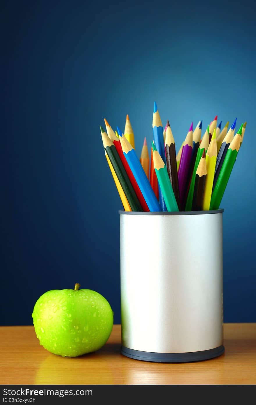 Pencils in a plastic cup on a blue background. Pencils in a plastic cup on a blue background