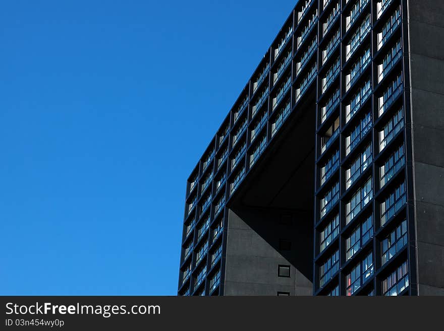 Fragment of modern building over bright blue sky. Fragment of modern building over bright blue sky