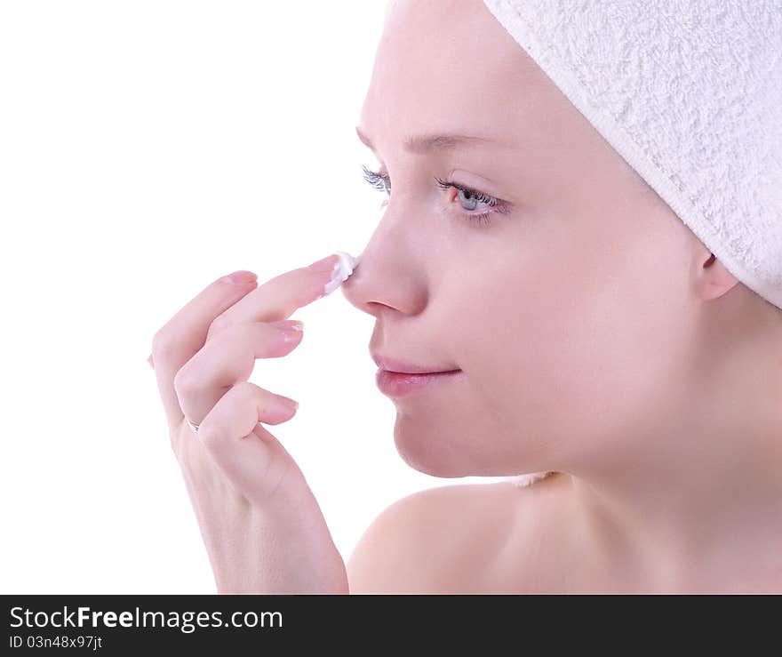 Girl after shower applying face cream