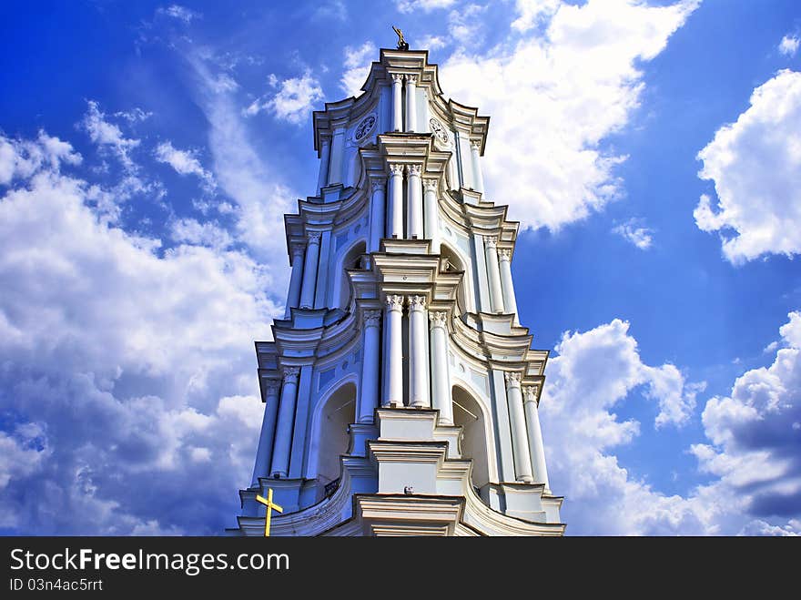 A belttower of a cathedral against the cloudy sky. A belttower of a cathedral against the cloudy sky.