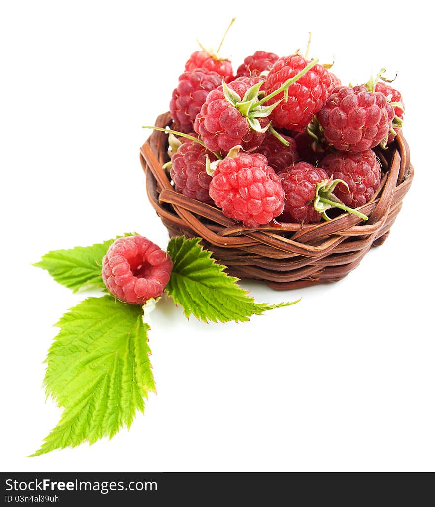 Raspberries with green leaves on a white background