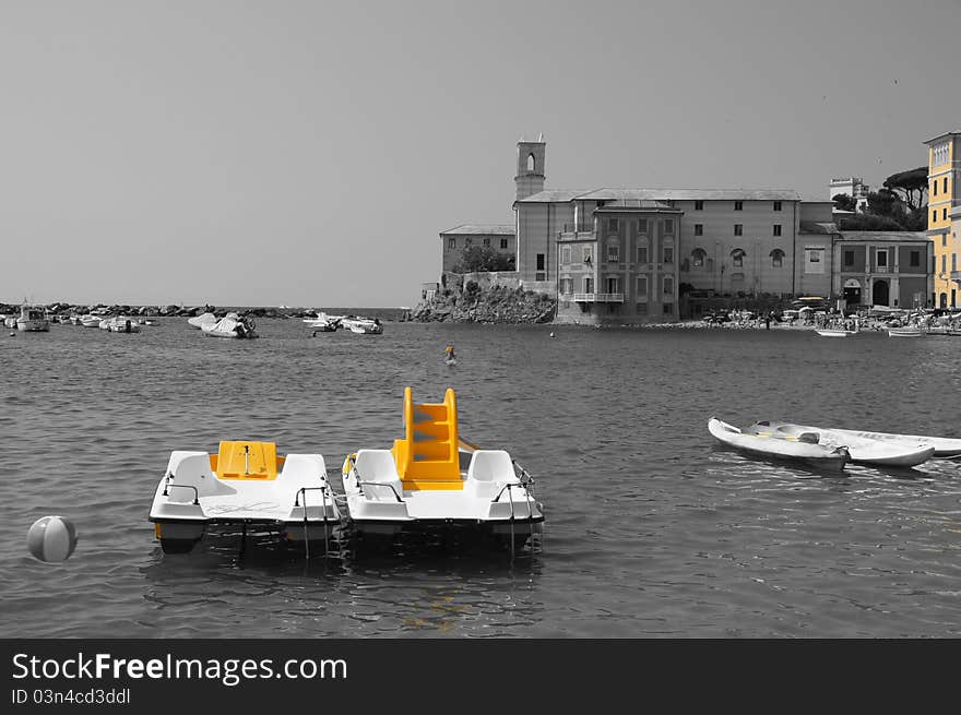 The bay of the old fishing village in Liguria, Italy. Old style landscape in black & white, only with yellow color. The bay of the old fishing village in Liguria, Italy. Old style landscape in black & white, only with yellow color.