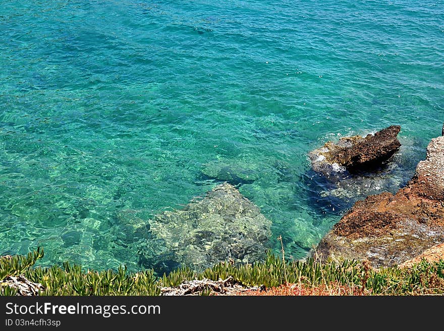 Rocky coast with blue-green water. Rocky coast with blue-green water