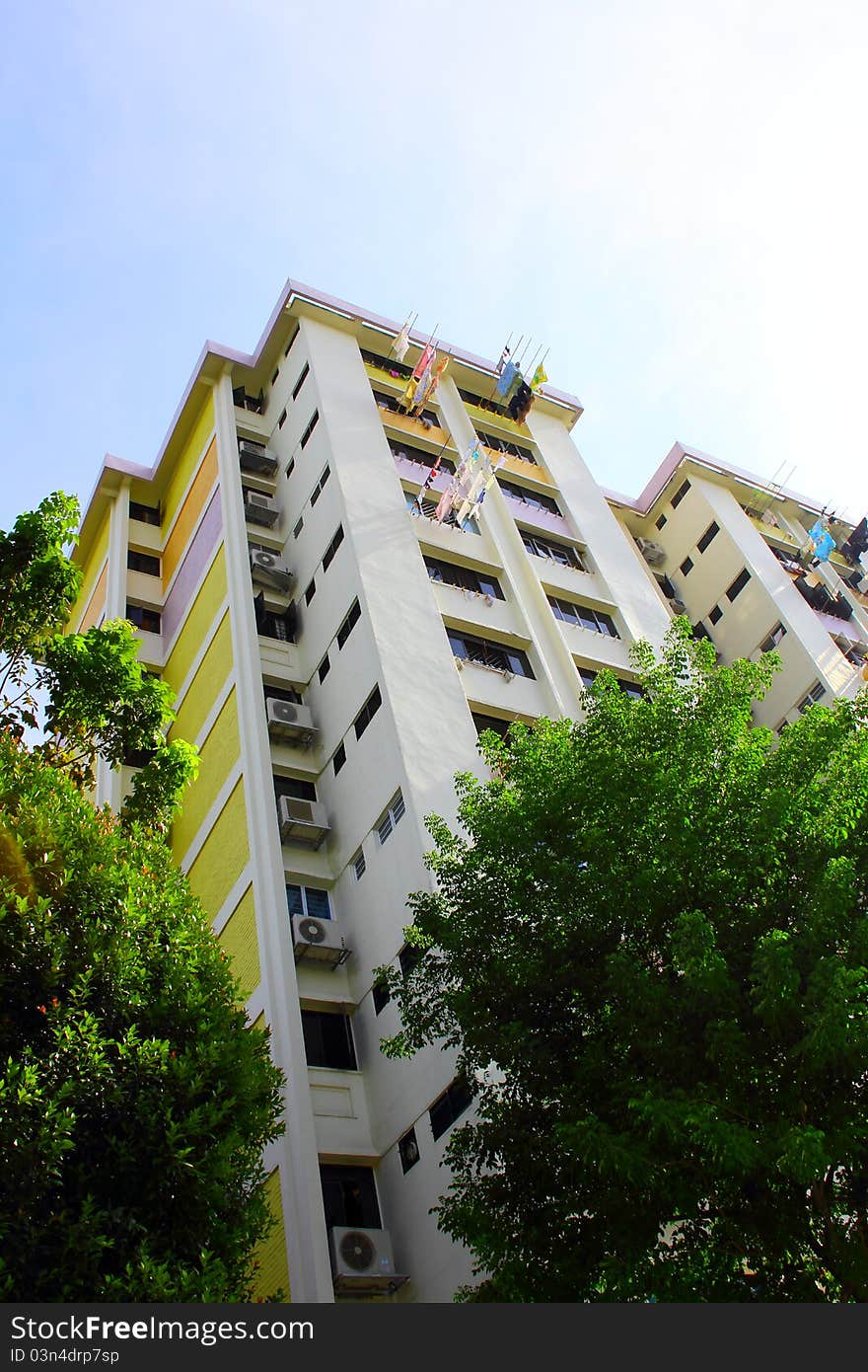 Singapore style, residential building with clothes drying in the air outside the windows