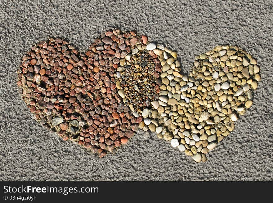 Stone mosaic on the sand after a rain