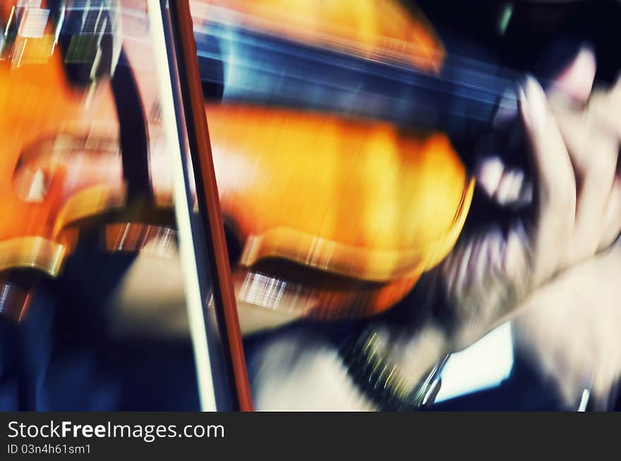 Closeup of blurred violin player in show. Closeup of blurred violin player in show