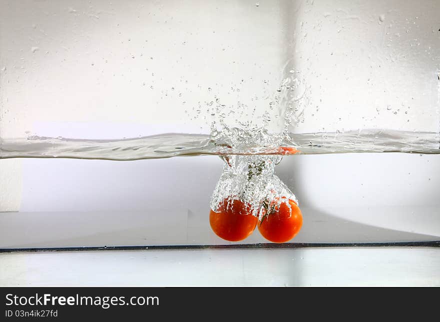 Tomatoes falling in water