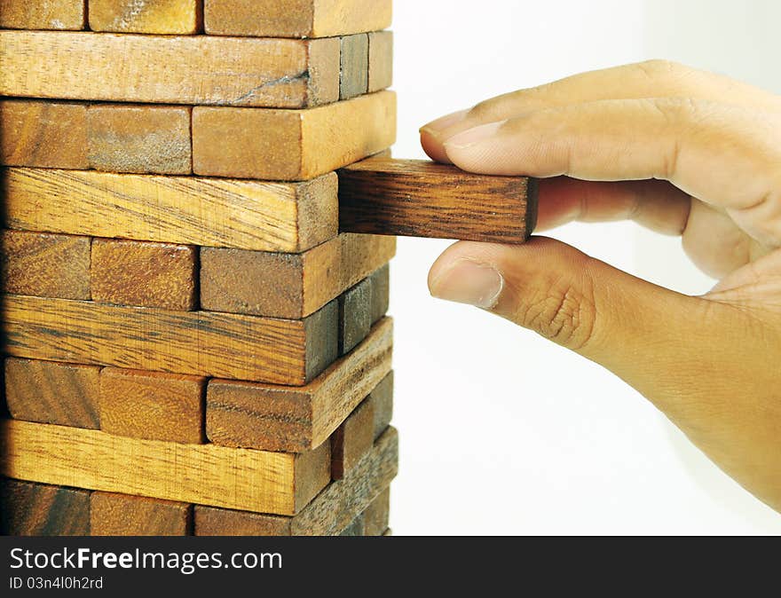 Wooden block toy and a piece in hand. Wooden block toy and a piece in hand