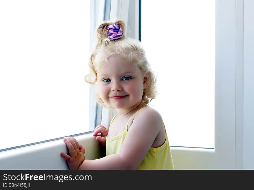 Smiling girl near the window