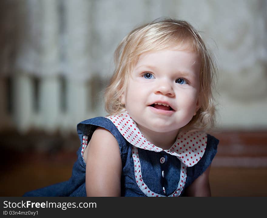 Girl sitting on the floor. Close-up portrait. Girl sitting on the floor. Close-up portrait