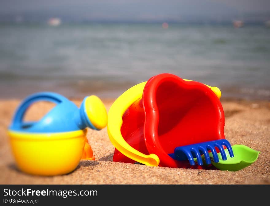 Children's toys on the beach on sea background