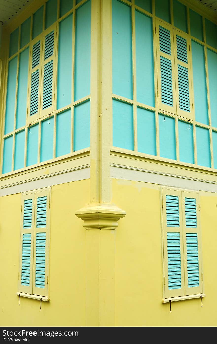 Blue windows on yellow wall in classic building. Blue windows on yellow wall in classic building.