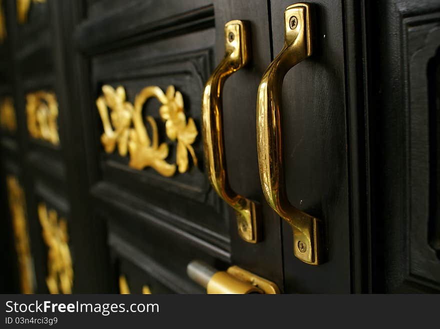 Golden door holders and wooden door at chino portugese house in Phuket. Golden door holders and wooden door at chino portugese house in Phuket