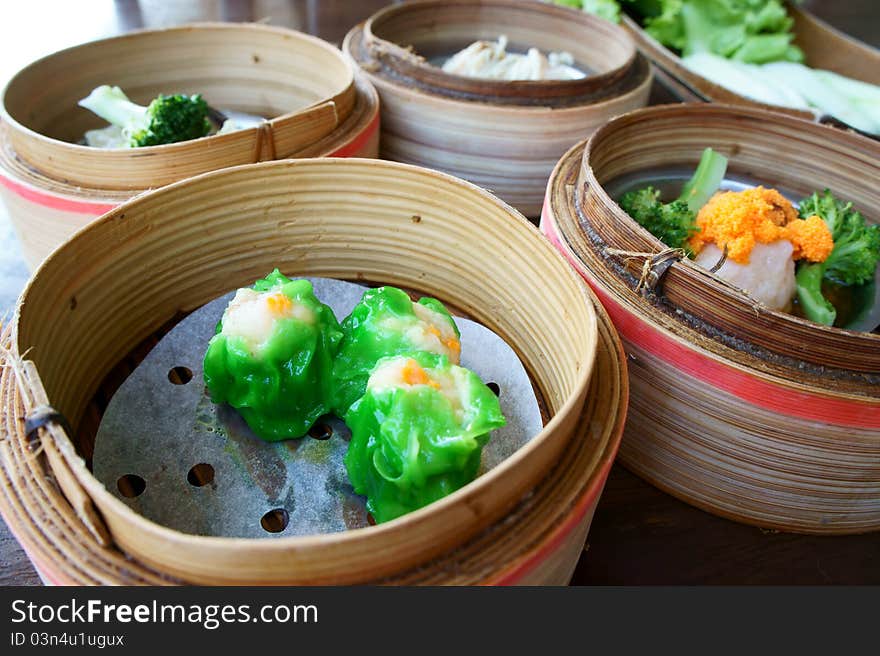 Chinese steamed dimsum in bamboo containers traditional cuisine