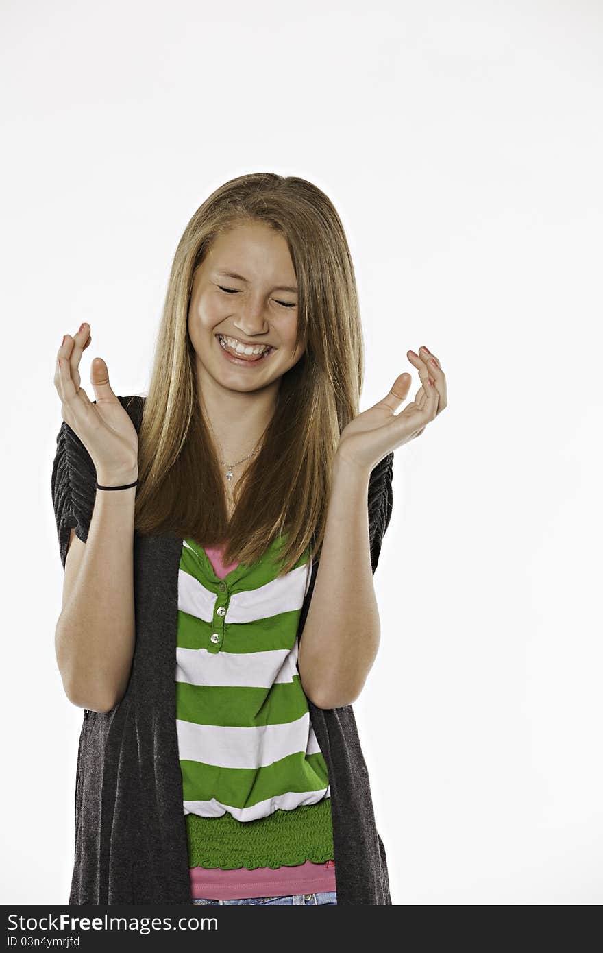 A happy laughing teenage female girl against a white background. A happy laughing teenage female girl against a white background