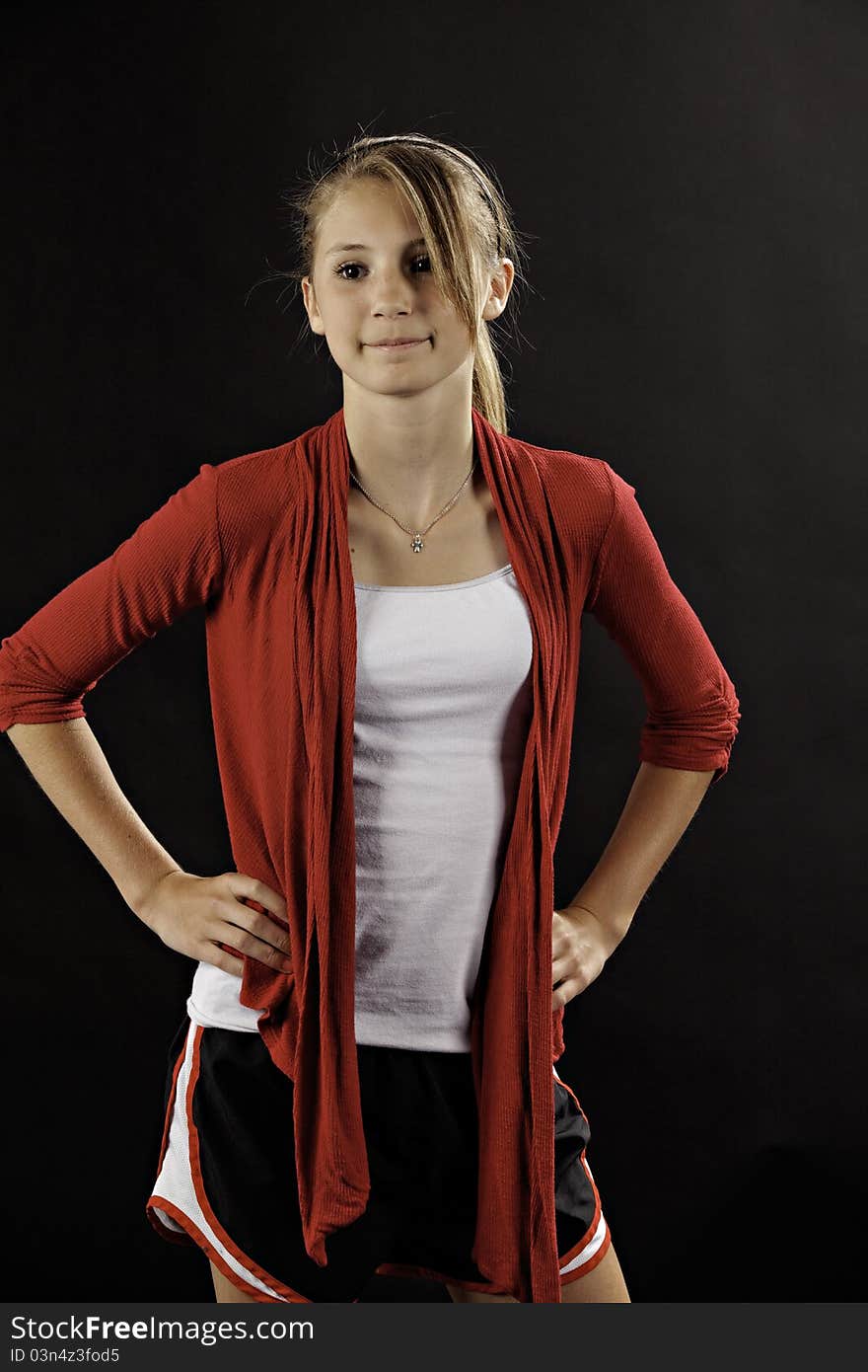 A teenage female girl in a casual pose against a black background. A teenage female girl in a casual pose against a black background.