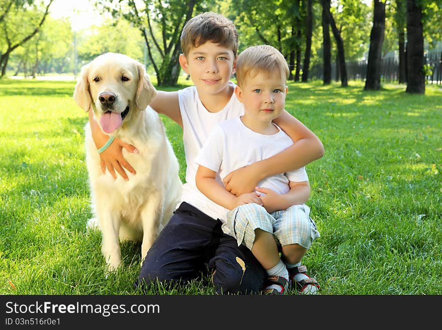 Little boy in the park with a dog