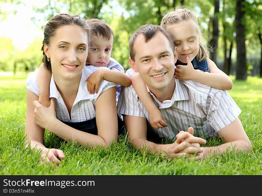 Family of mother, father and children together in the park. Family of mother, father and children together in the park