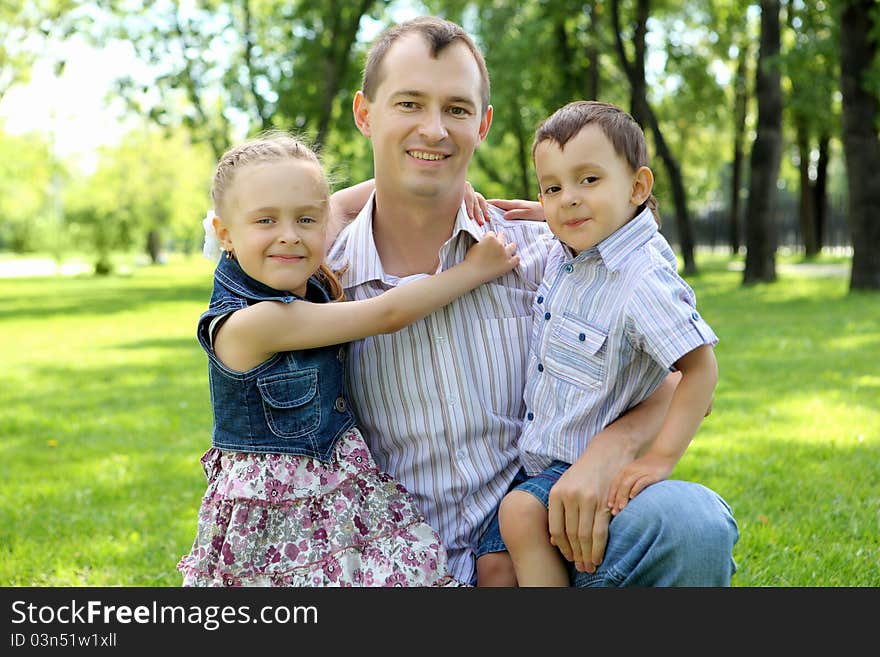 Father with son and daugther  together in the park. Father with son and daugther  together in the park