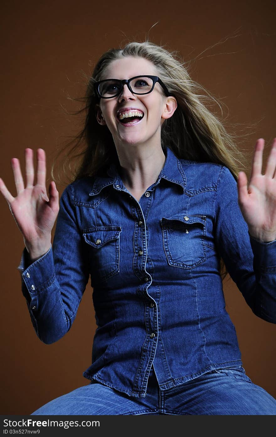 Happy woman in glass on the brown background