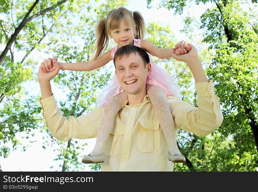 Father with daugther outside in the summer park