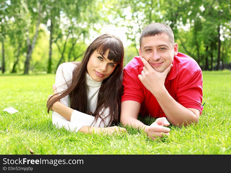 Romantic couple spending time together in the summer park. Romantic couple spending time together in the summer park