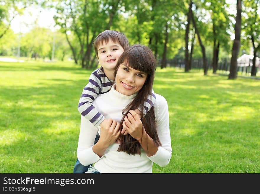 Mother with her son outside in the summer park. Mother with her son outside in the summer park