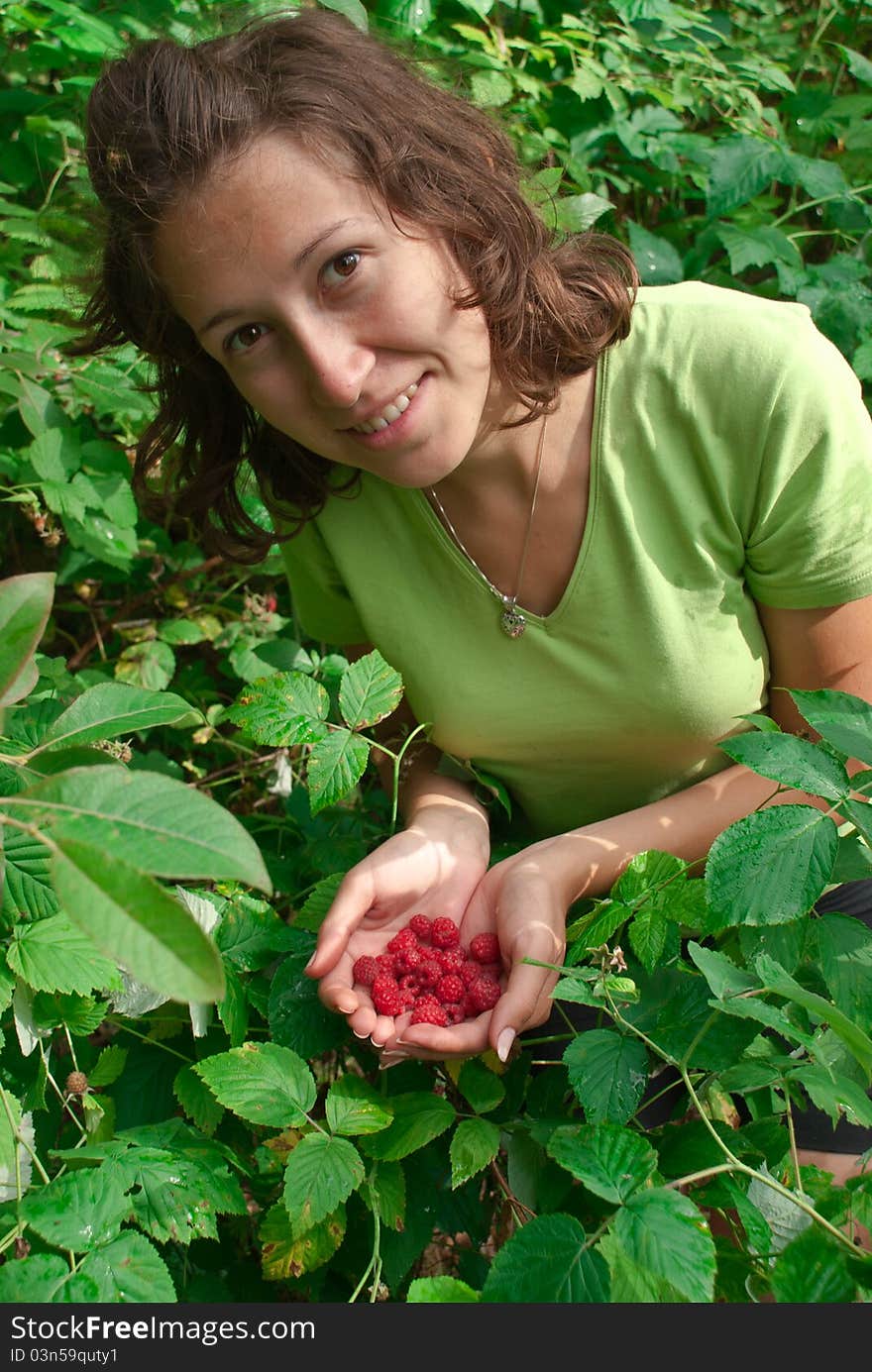 Girl holding fresh, delicious raspberries