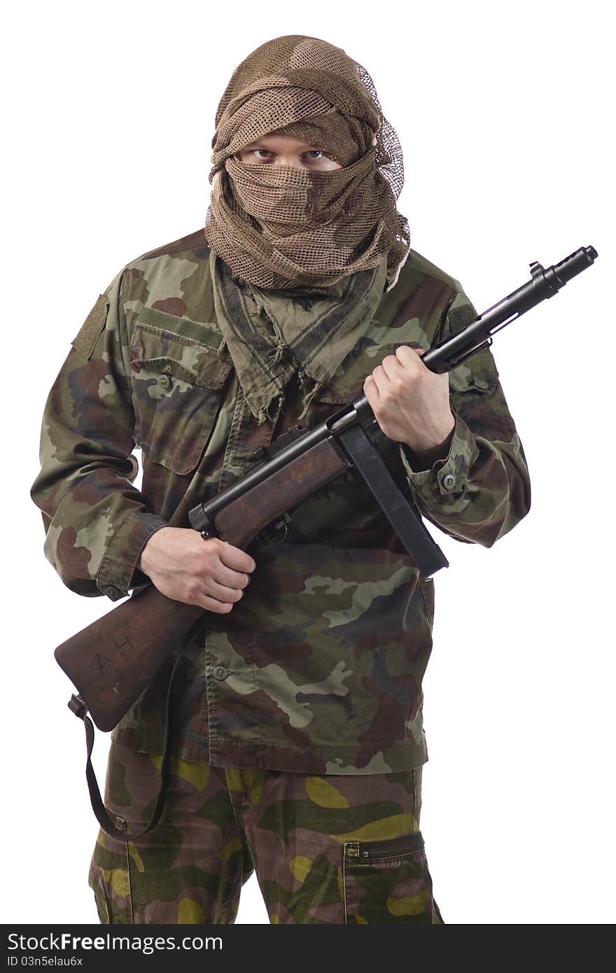 Camouflaged guerrilla soldier with hidden face and a machine gun. Isolated on white background. Camouflaged guerrilla soldier with hidden face and a machine gun. Isolated on white background.