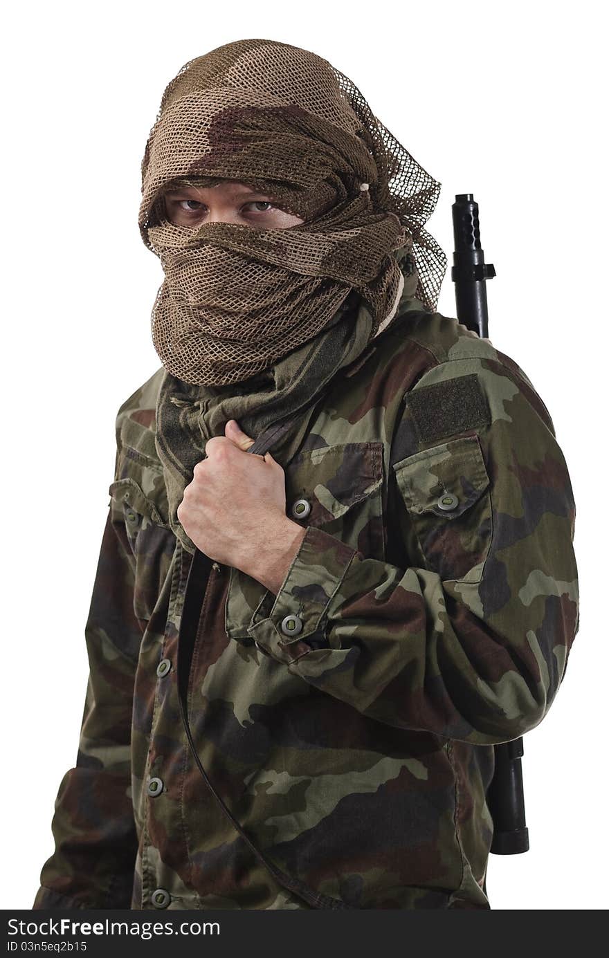 Camouflaged guerrilla soldier with hidden face and a machine gun. Isolated on white background. Camouflaged guerrilla soldier with hidden face and a machine gun. Isolated on white background.