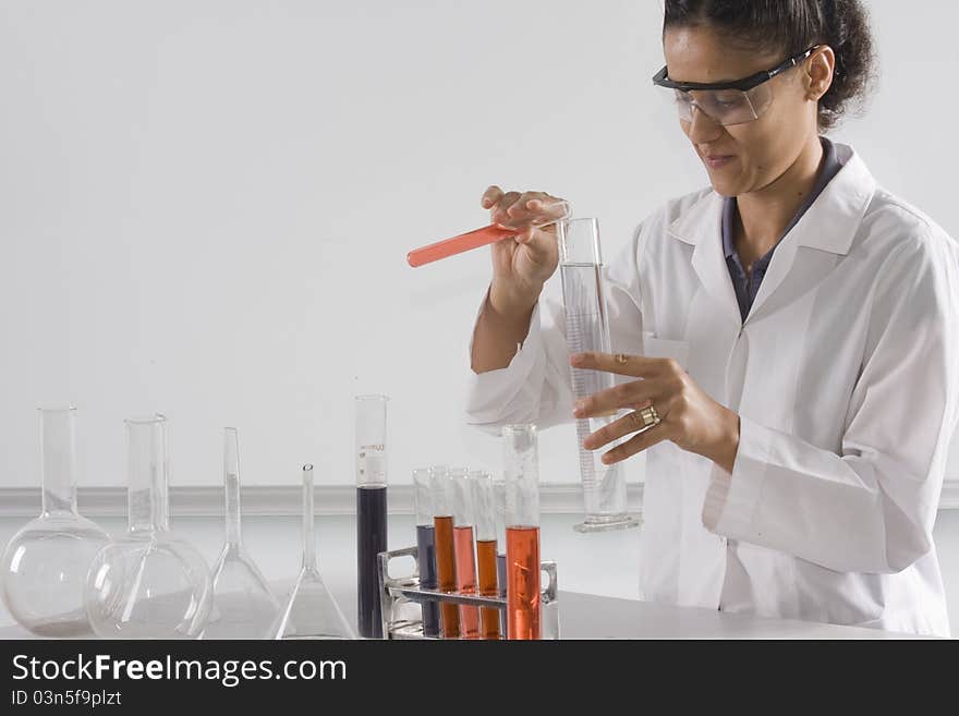 Female lab tech mixing liquids