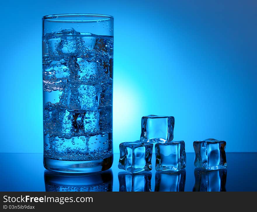 Ice cubes and cold water in glass