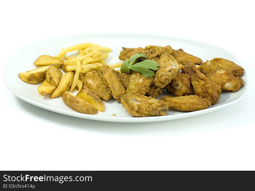 Golden fried chicken and fried potatoes in a white plate