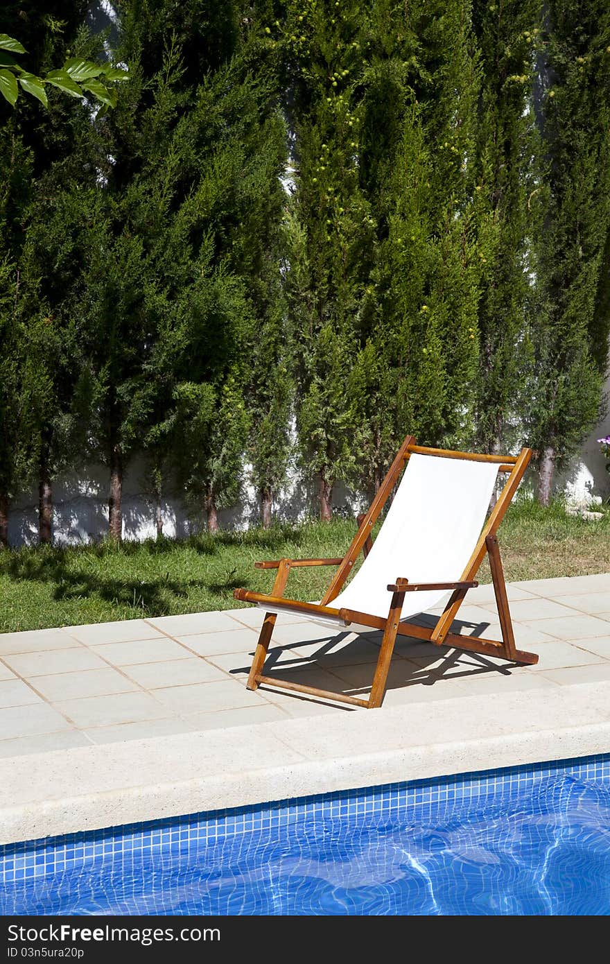 Deckchair in a swimming pool on a summer day