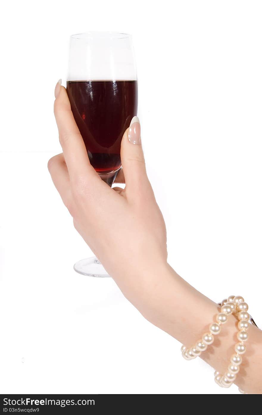 Hand with pearl bracelet holding wineglass