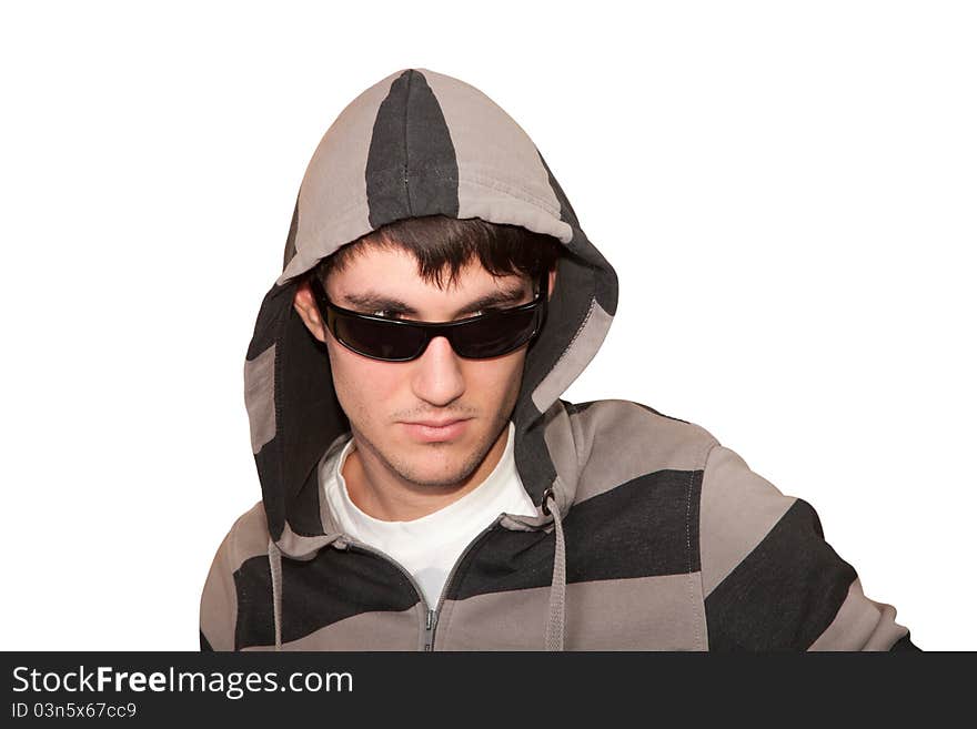 Young man with a hood and sunglasses on white background isolated. Young man with a hood and sunglasses on white background isolated