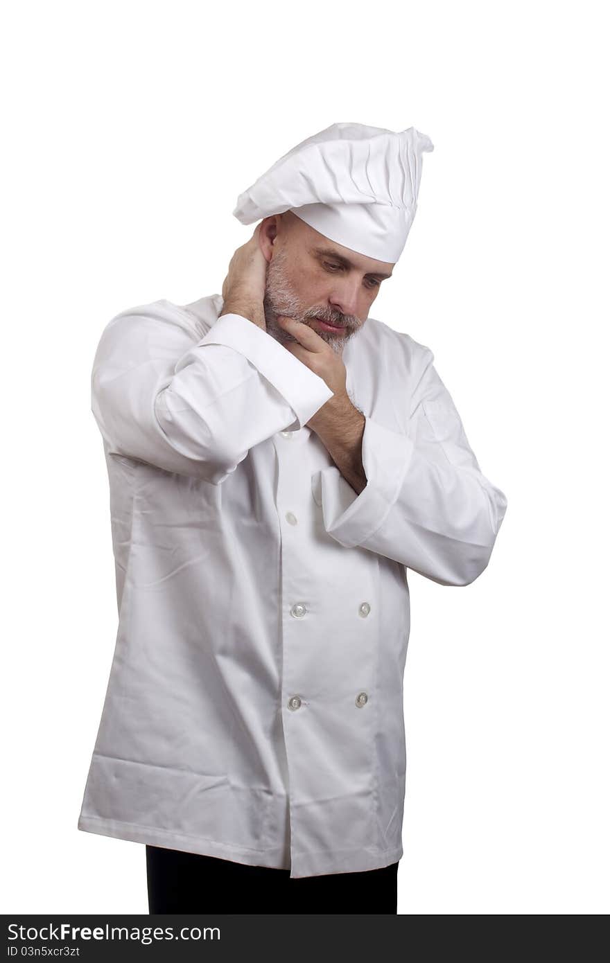 Portrait of a chef in a chef's hat and uniform looking down and thinking isolated on a white background.