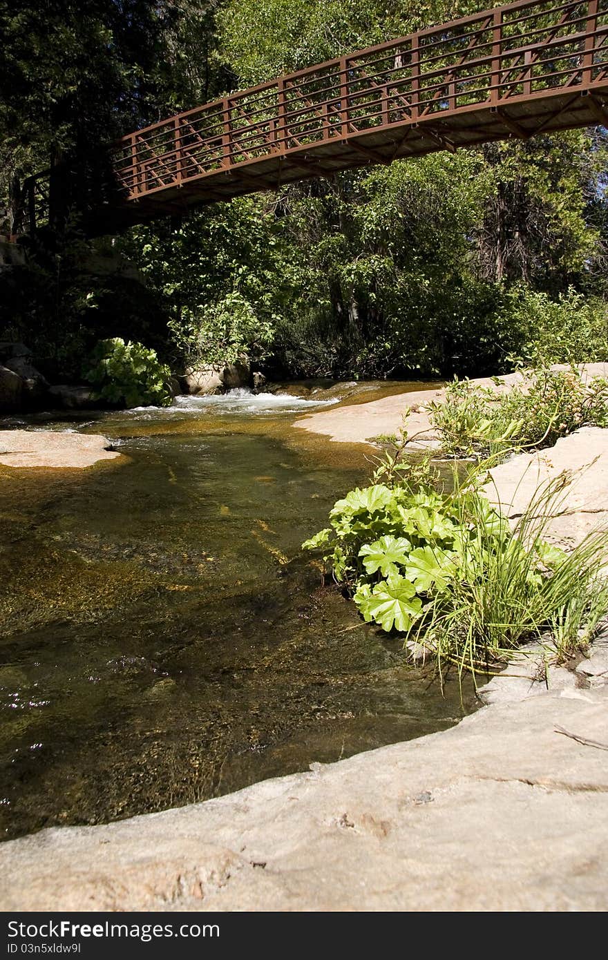 Small bridge over gently running stream. Small bridge over gently running stream