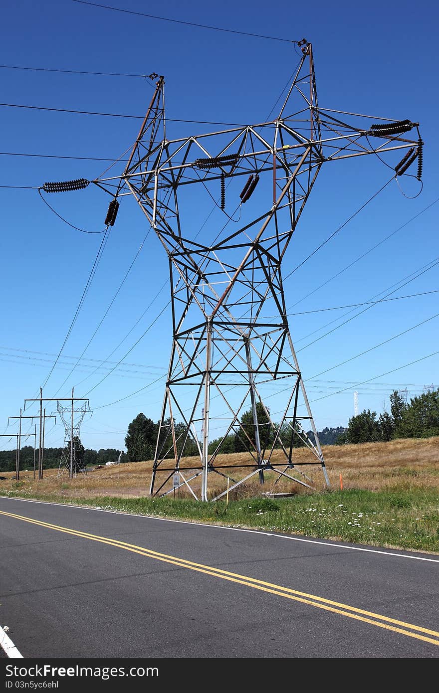 A wide power-line tower connecting various lines of electrical wires. A wide power-line tower connecting various lines of electrical wires.