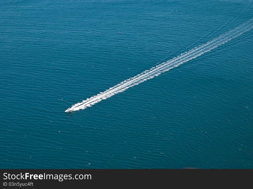 Motorboat is moving rapidly on the surface of the sea. Motorboat is moving rapidly on the surface of the sea