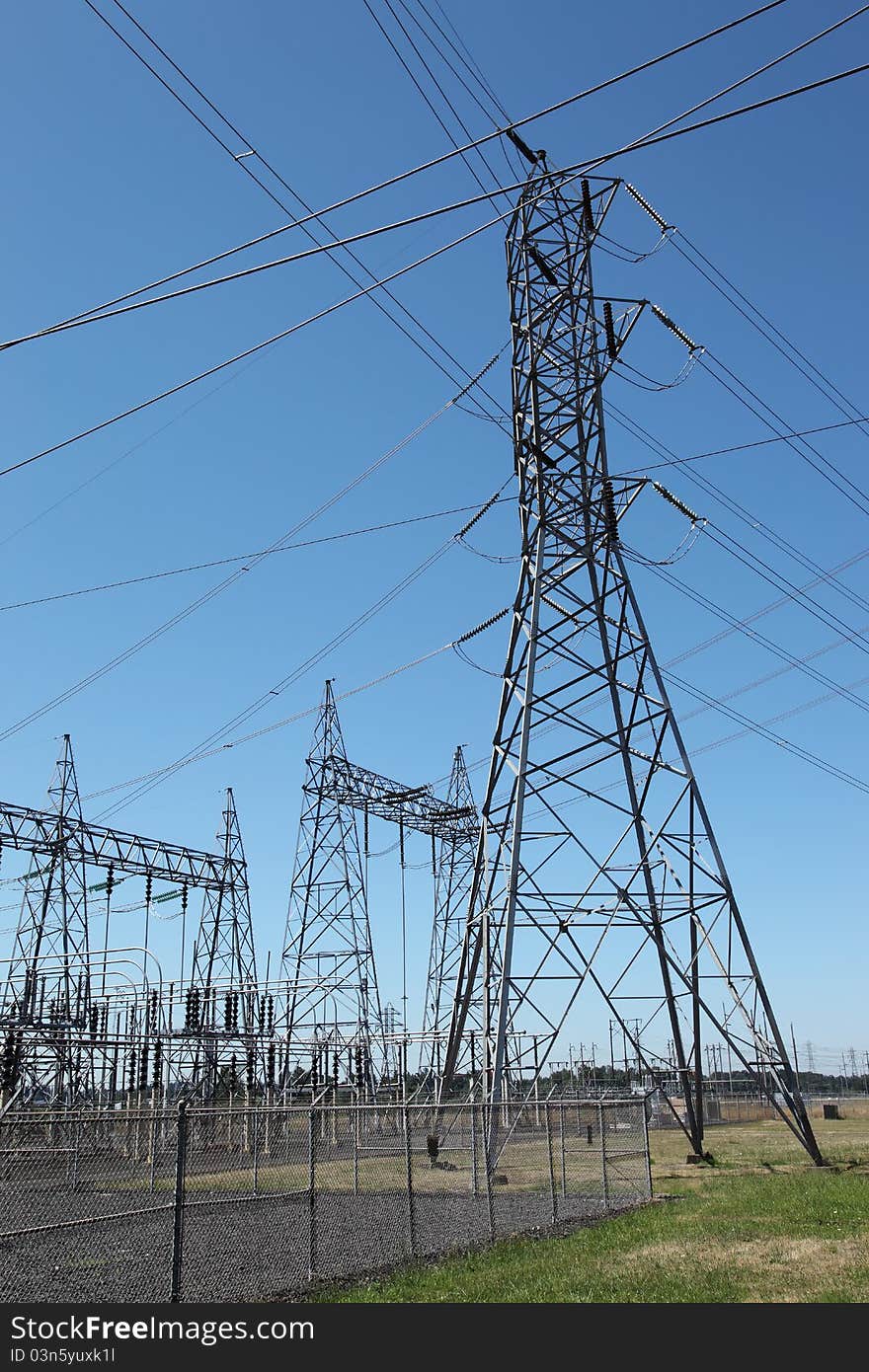 Cris crossing power-lines and towers connecting electrical energy to various directions. Cris crossing power-lines and towers connecting electrical energy to various directions.